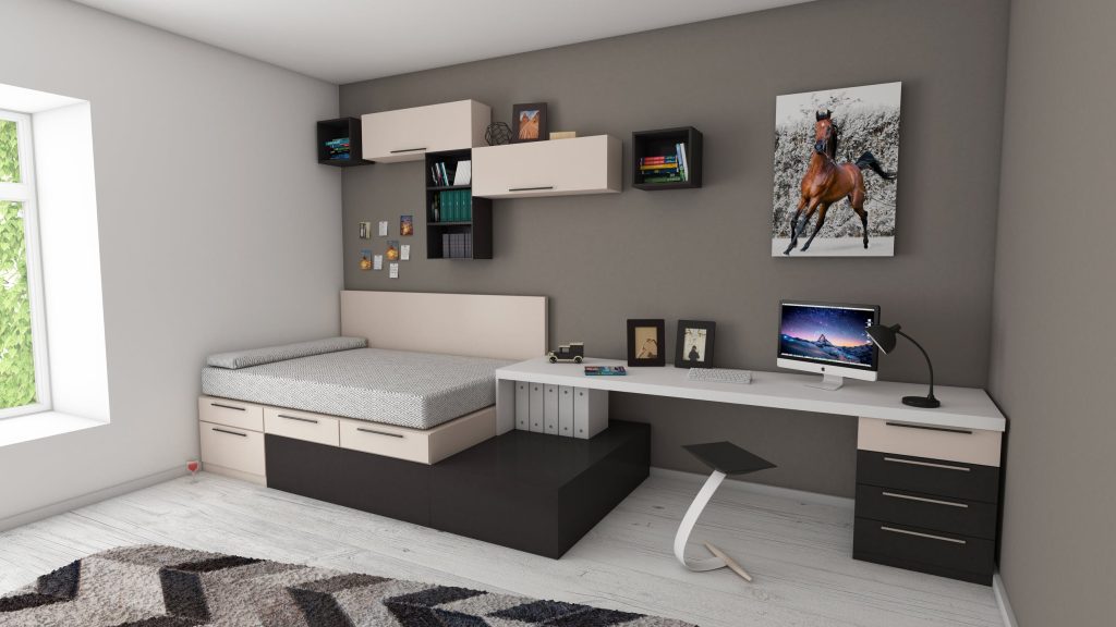 Uma cama multifuncional com armários e uma mesa conectada ao móvel.